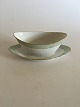 Royal 
Copenhagen 
Green Curved 
with Gold Oval 
Sauceboat No 
1651. 9 x 23.5 
cm (3 35/64" x 
9 1/4")