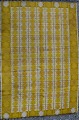 Rölakan tæppe med geometrisk mønster i gule nuancer. 
