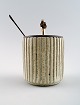 Arne Bang and Georg Jensen: Jam Jar in stoneware modeled with vertically fluted 
pattern. Decorated with light gray glaze.
With lid and jam spoon in sterling silver.