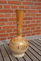 Vase with slim 
neck, decorated 
with flowers 
and 
butterflies, 
and with gold 
edges. The vase 
is in ...