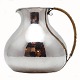 Hans Hansen: 
Karl Gustav 
Hansen. A round 
chubby pitcher 
of lightly 
hammered 
sterling silver 
with ...