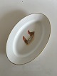 Oval Serving 
Dish with Two 
Gnomes Eating a 
Fish. 34 x 22 
cm (13 25/64" x 
8 21/32"). The 
gold is ...