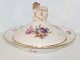 Royal 
Copenhagen 
Saxon Flower, 
round lidded 
bowl with 
figurine of a 
boy.
Decoration 
number ...
