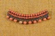 Brooch with 
coral beads 
mounted on 
brass in 2 
rows, complete 
with decorative 
border adorned 
with ...