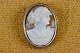 Cameo Roman 
lady head 
carved from 
conch, mounted 
in silver frame 
surrounded by 
decorations. 
The ...