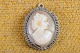 Cameo mini 
pendant with a 
lady head cut 
off conch, 
mounted in 
silver frame 
finely 
decorated edge 
...