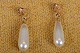 Earring Studs 
in gold with 
pear-shaped 
pearl. Stamped 
18 K 3-kroner 
(Serige). 
Size.: L 2,5 cm 
...