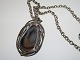 Anette Bord.
Large metal 
pendant with 
stone in long 
chain from 
1970-1980.
The pendant 
...