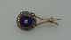 Brooch in 8 carat gold with blue enamel and rned ring of small and large real pearls. A total of ...