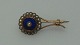 Brooch in 8 
carat gold with 
blue enamel and 
rned ring of 
small and large 
real pearls. A 
total of ...