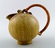 Arne Bang art pottery pitcher with wicker handle. Model number 151.