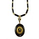Jewellery.
A medallion 
and necklace of 

14k gold and 
black enamel.
Set with 
diamonds and 
...