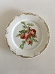 Royal 
Copenhagen 
Plate with 
Handpainted 
Fruit Motif and 
Goldornament. 
23 cm dia (9 
1/16"). In ...
