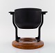 Flemming Digsmed, fondue pot in cast iron on stand of teak.
