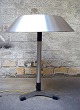 Jo Hammerborg. Table lamp, model President of polished steel, spacers and legs 
of black wood.
Produced by Fog & Morup.