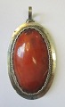 Oval amber 
pendant, 20th 
century. 
Denmark. 
Polished amber 
with silver 
frame. 
Unstamped. 5 x 
3 cm.