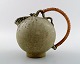 Arne Bang art pottery pitcher with wicker handle. Model number 151.