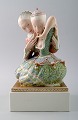 Royal Copenhagen. Gerhard Henning: "Eventyr I" figurgruppe af porcelæn, 
dekoreret i overglasurfarver og guld.