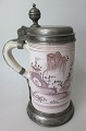 German faience 
mug with pewter 
fitting, 1737. 
Mug decorated 
in Chinese 
style with man 
in garden. ...