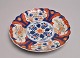 Imari Dish, 
19th Century. 
Japan. With 
waved edge. 
Polycrom 
decoration with 
flowers. Dia: 
30 cm.