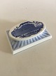 Royal 
Copenhagen 
Paper Press 
from 1920 with 
Motif of 
Amalienborg 
Castle. 
Measures 15 x 
10 cm. In ...