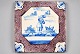 Dutch tile, 
blue and 
manganese 
decorated, 18th 
century. A 
shepherd on the 
ground. 13 x 13 
cm.