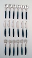 Complete dinner service for 6 p., Henning Koppel for Georg Jensen. Stainless 
steel and green plastic cutlery.