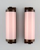 Scandinavian designer, a pair of Art Deco wall lamps in brass with pink glass 
shades.