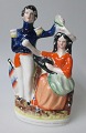 Staffordshire 
figure of young 
couple, approx. 
1830-1840, 
England. 
Polycrom 
decoration. 
Height: ...