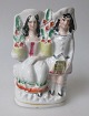 Staffordshire 
figure of a 
young couple 
with flowers, 
approx. 1840, 
England. 
Polycrom 
decorated. ...