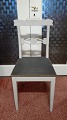 Gray-painted 
dining table 
chairs 
gray-painted 
with black seat 
Sweden 1800s 
Front with 
traces of ...