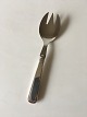 Olympia Cohr 
Salad Serving 
Fork in Silver 
and Stainless 
Steel. 17 cm L