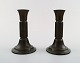 Just Andersen bronze candlesticks.
