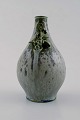 Arne Bang. Ceramic vase with foliage.
