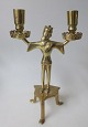 Copy after 
Gothic Stage, 
Brass, 19/20. 
C. Three legs 
with man 
holding two 
candlesticks - 
one in ...