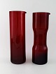 Kaj Franck (Finnish, 1911-1989) Nuutajärvi Glass Works, Finland, art glass. Two 
pitchers of red art glass.