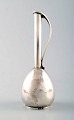 C. C. Hermann: Small modernistic orchid vase of sterling silver.

