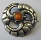 Danish silver 
art nouveau 
brooch with 
amber, H. 
Fischer (1893 - 
1937), 
Copenhagen. 
Stamped. Dia: 
...