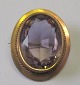 Gold plated oval brooch with sliced ??aquamarine, approx. 1900. 3 x 2.5 cm.