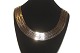 Geneva Necklace 
3 Rk., 14 Carat 
Gold
Stamped: 585. 
BNH
Length 50 cm.
Width 2.5 cm
Thickness ...