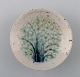 Snorre Stephensen: Lille skål af stentøj dekoreret med træ i blå og grøn glasur 
samt med transparent overglasur.