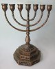 7 armed 
candlestick in 
patinated 
bronze - 
Menorah. 20th 
C. Denmark. 
With 6 edged 
base with ...