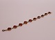Bracelet with 
heart shaped 
pieces of amber 
and og silver.
20 cm and 1x1 
cm.