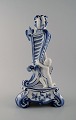 Royal Copenhagen. Candlestick of porcelain, Blue Fluted no. 1/13 with bird and 
fawn sitting on tripod base.