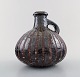 Gutte Eriksen own workshop, pottery pitcher.
Metallic glaze, raku burned.