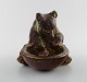 Rare Royal Copenhagen stoneware figure of brown bear with a vessel by Knud Kyhn. 
No. 21737.