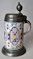 German faience 
beer mug, 1791. 
Polycrom 
decorated with 
poppies and 
manganese. 
Pewter mounting 
...