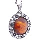N. E. From; A 
pendant with 
amber mounted 
in sterling 
silver with 
leafs and 
flowers. Diam. 
3,5 ...