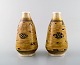 Theodor Larsen 
for Royal 
Copenhagen. A 
pair of 
porcelain vases 
decorated in 
gold and black. 
...