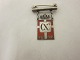 Royal batch made of Sterling silver 925S with red 
enamel motif of the Dannebrog
This batch is made as a brooch with a beam
Year 1870-1945 is on as well as Christian X
The Silver smithy of Georg Jensen produced it in 
1940-47